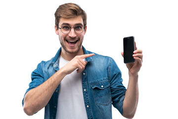 Portrait of a cheerful young man in jeans t-shirt isolated over transparent backgound, showing blank screen mobile phone