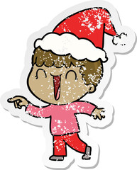 laughing distressed sticker cartoon of a man pointing wearing santa hat
