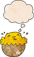 cartoon hatching chick and thought bubble in grunge texture pattern style