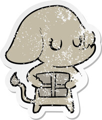 distressed sticker of a cute cartoon elephant with gift