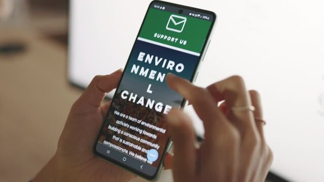 Hands, phone and scrolling on sustainable homepage screen by woman for research at office. Female scroll through website logo of environmental or climate change on smartphone display or mobile app