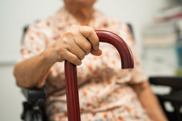 Asian elderly disability woman holding waling stick, wood cane, round handle, walking aid for help...