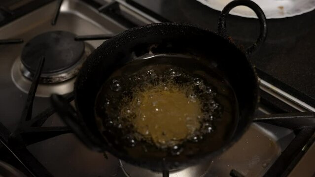 Overhead View Of Bubbling Guror Handesh In Hot Oil Pan On Cooker. Slow Motion