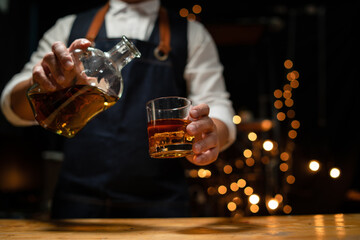 Barman pouring whiskey whiskey glass beautiful night