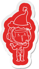 laughing cartoon  sticker of a astronaut wearing santa hat