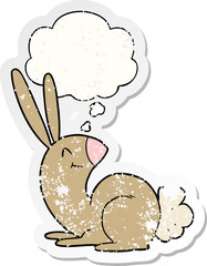 cute cartoon rabbit and thought bubble as a distressed worn sticker