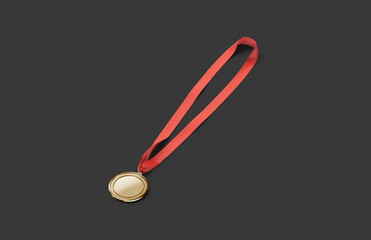 Blank gold medal with red ribbon mockup lying, dark background