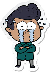 sticker of a cartoon crying man with crossed arms
