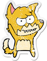 distressed sticker of a cartoon grinning fox