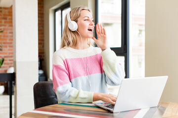 Obraz premium pretty young woman working at home with a laptop. house interior design