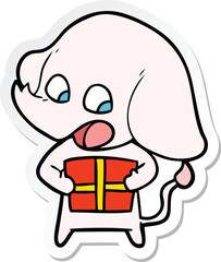 sticker of a cute cartoon elephant with christmas present