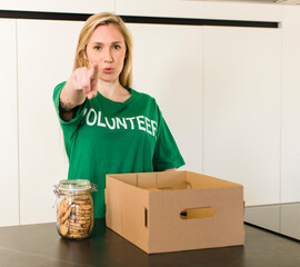 young adult pretty blonde woman. volunteer and donation concept