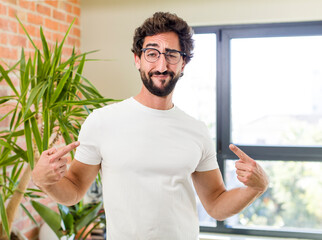 young adult crazy man with expressive pose at a modern house interior