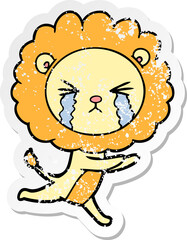 distressed sticker of a cartoon crying lion
