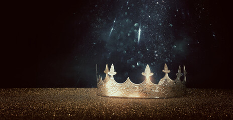 low key image of beautiful queen or king crown over glitter table. fantasy medieval period
