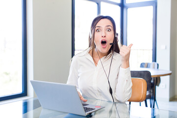 young pretty woman looking astonished in disbelief. telemarketer concept