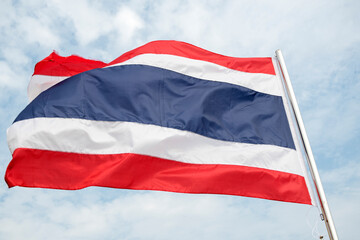 Fototapeta na wymiar Thailand flag waving in wind with beautiful blue sky