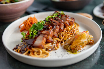 Stewed pork slice with noodles and vegetables in plate