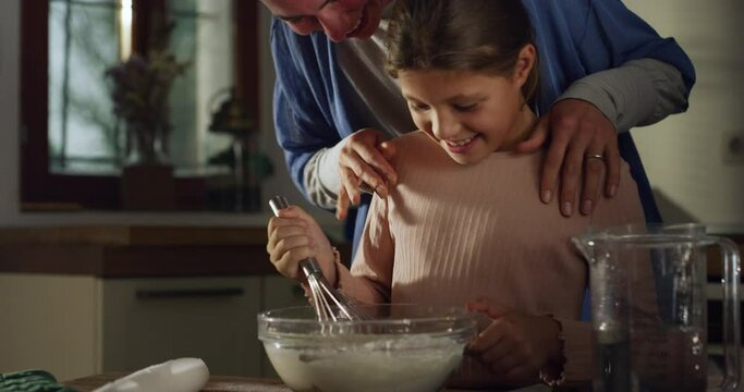 Authentic Shot of Mother and Daughter in the Kitchen Preparing for Baking a Cake. Little Cute Girl Helping her Mother with the House Shores and Cooking, Spending Bonding Time Together