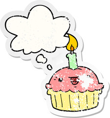 cartoon cupcake with candle and thought bubble as a distressed worn sticker