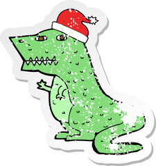 retro distressed sticker of a cartoon dinosaur in christmas hat