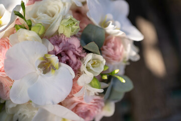 The bride holds a wedding bouquet of white orchids. Wedding decor ideas
