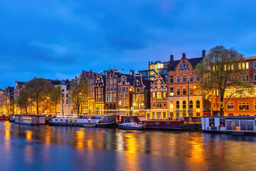 Amsterdam Netherlands, night city skyline at canal waterfront