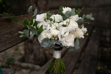 Wedding bouquet of white flowers - ranunculus, freesia, lisianthus.. Wedding. Bride and groom.