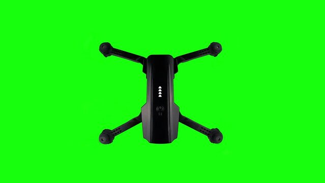 Flying drone isolated on chroma key. View from top quadrocopter on a green screen. Seamless loop