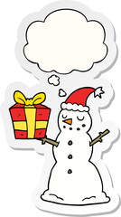 cartoon snowman with present and thought bubble as a printed sticker