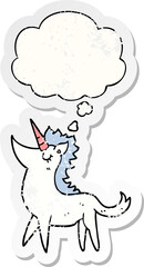 cartoon unicorn and thought bubble as a distressed worn sticker