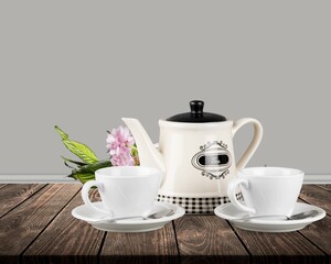 Tea concept, teapot and cups on the desk