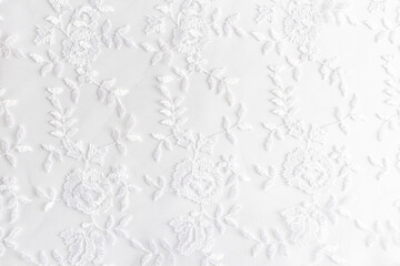 White lace with small flowers on the white background. - obrazy, fototapety, plakaty
