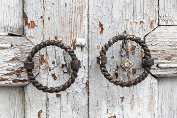 Antique round metal handles on wooden gates