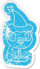 cartoon distressed sticker of a bearded man crying wearing santa hat