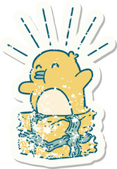 grunge sticker of tattoo style penguin sitting on present