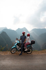 Backpacking couple enjoys a trip through Southeast Asia on their motorcycle trip through the HA GIANG loop, Vietnam