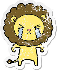 distressed sticker of a cartoon crying lion