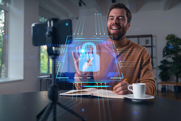 Happy man is making video blog using smartphone on a tripod explaining, teaching, master class...