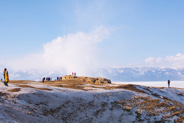 Olkhon Island, Baikal, Russia- February 22, 2023 : people make a wish on the Shamanka stone