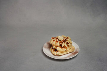 Plate of Homemade Belgian Waffles on Grey concrete Background