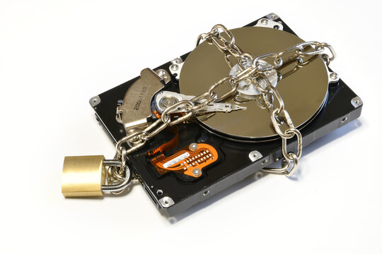 Open hard drive secured with an iron chain and padlock. Cyber ​​security concept. Data of hard drive secured by padlock