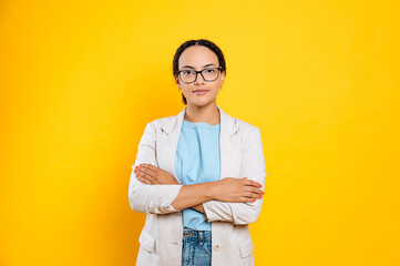 Pretty, confident successful mixed race business lady with glasses, in elegant wear, executive,...