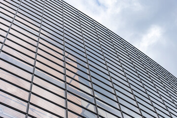 Fototapeta na wymiar The wall of glass windows of a building.