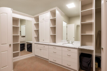 Dressing room has plenty of storage with built-in shelves and drawers. Mirror and vanity table for getting ready in the morning. AI technology. 