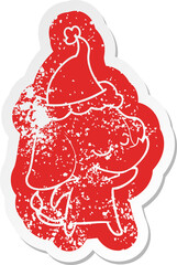 cartoon distressed sticker of a smiling elephant wearing santa hat