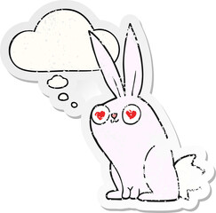 cartoon bunny rabbit in love and thought bubble as a distressed worn sticker