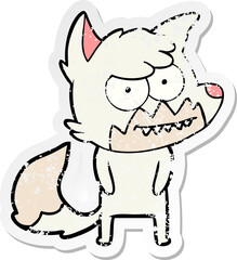 distressed sticker of a cartoon grinning fox