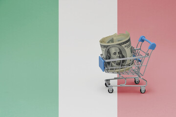 Metal shopping basket with dollar money banknote on the national flag of italy background. consumer basket concept. 3d illustration