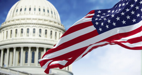 Flag of the United States waving with the American Capitol blurred in the background
